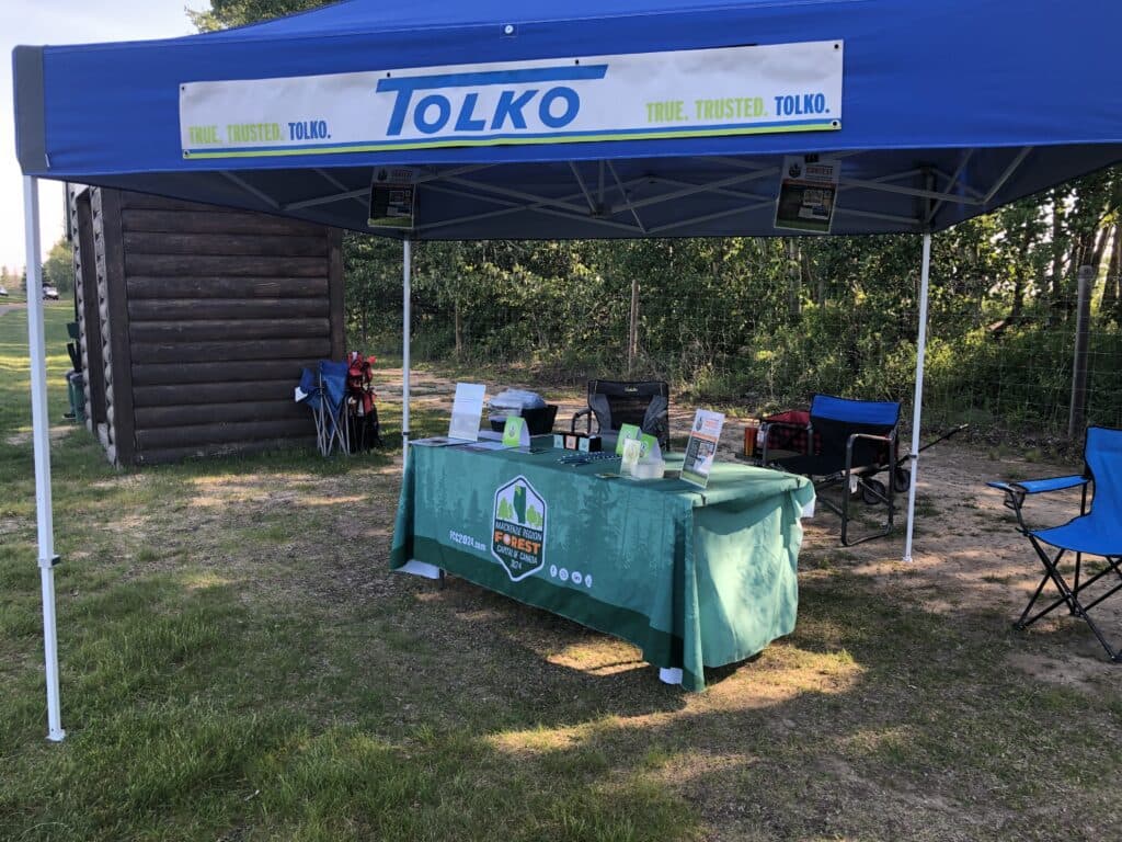 Photo of Forest Capital of Canada 2024 table under Tolko tent.